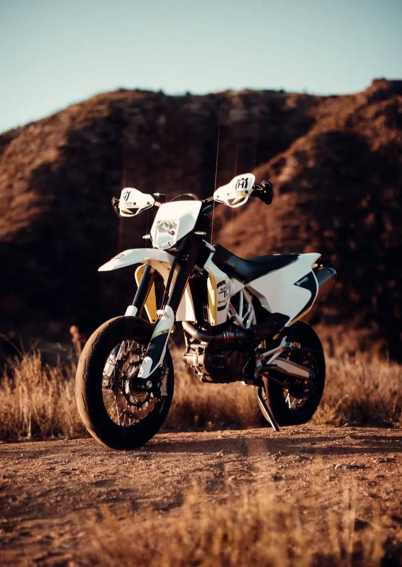 Old custom beautiful racer motorcycle in the desert at sunset or sunrise