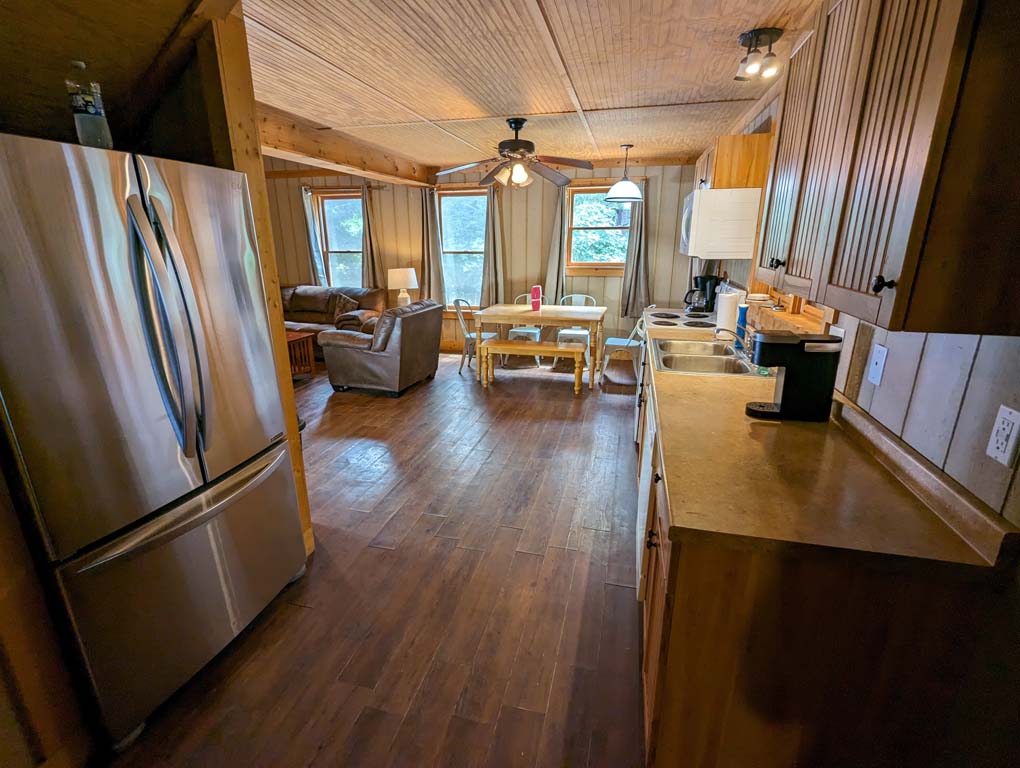 A kitchen in a chalet, with a table and chairs for dining