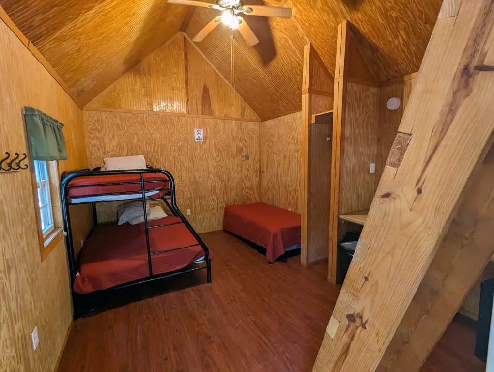 A bunkbed and a twin bed in a camping cabin
